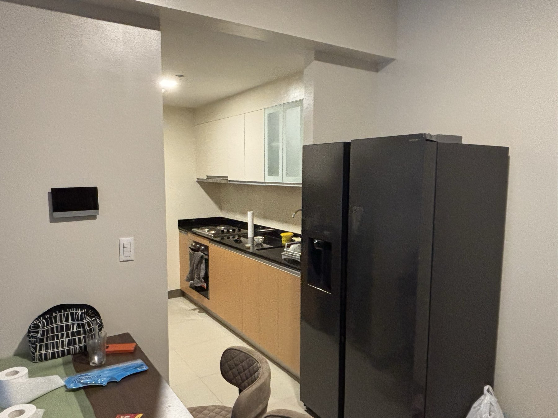 Large side-by-side fridge with water and ice dispenser, beside the galley kitchen